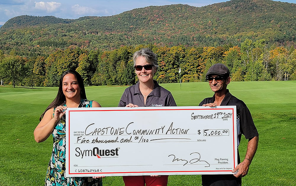 SymQuest Presents Check to Capstone Community Action